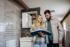 happy couple of adults choosing ceramic tile for bathroom